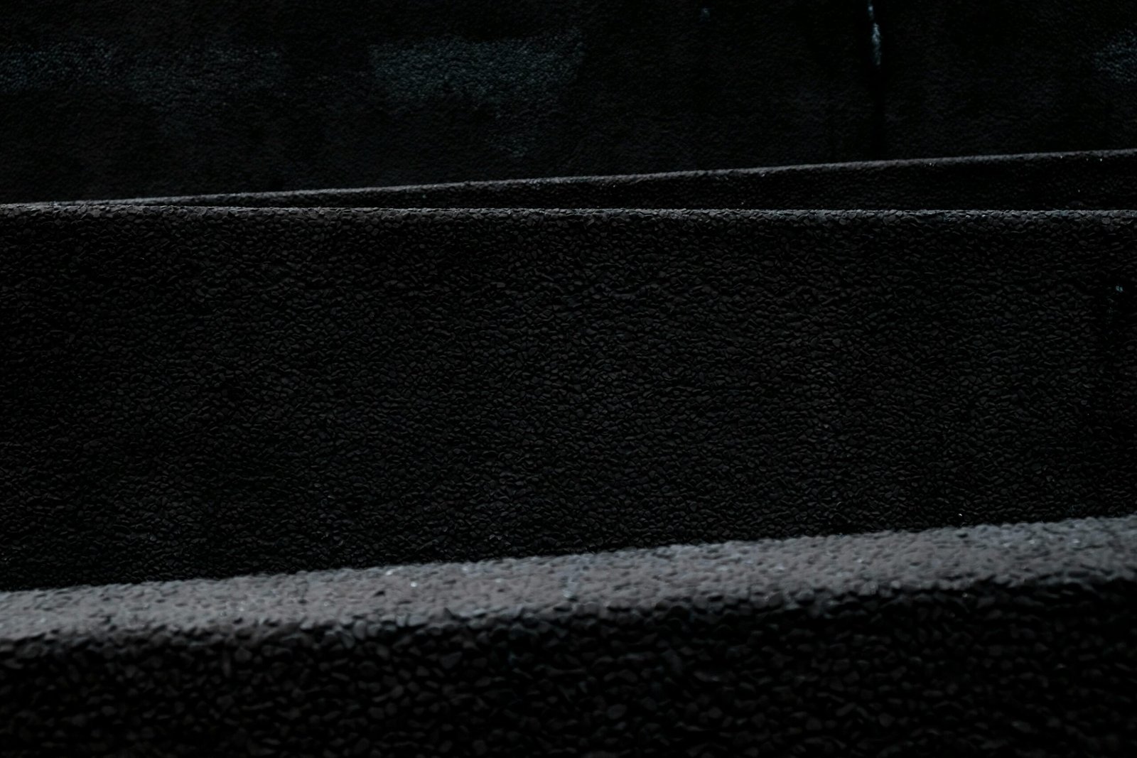 A dark and minimalist black texture pattern ideal for backgrounds and design use.