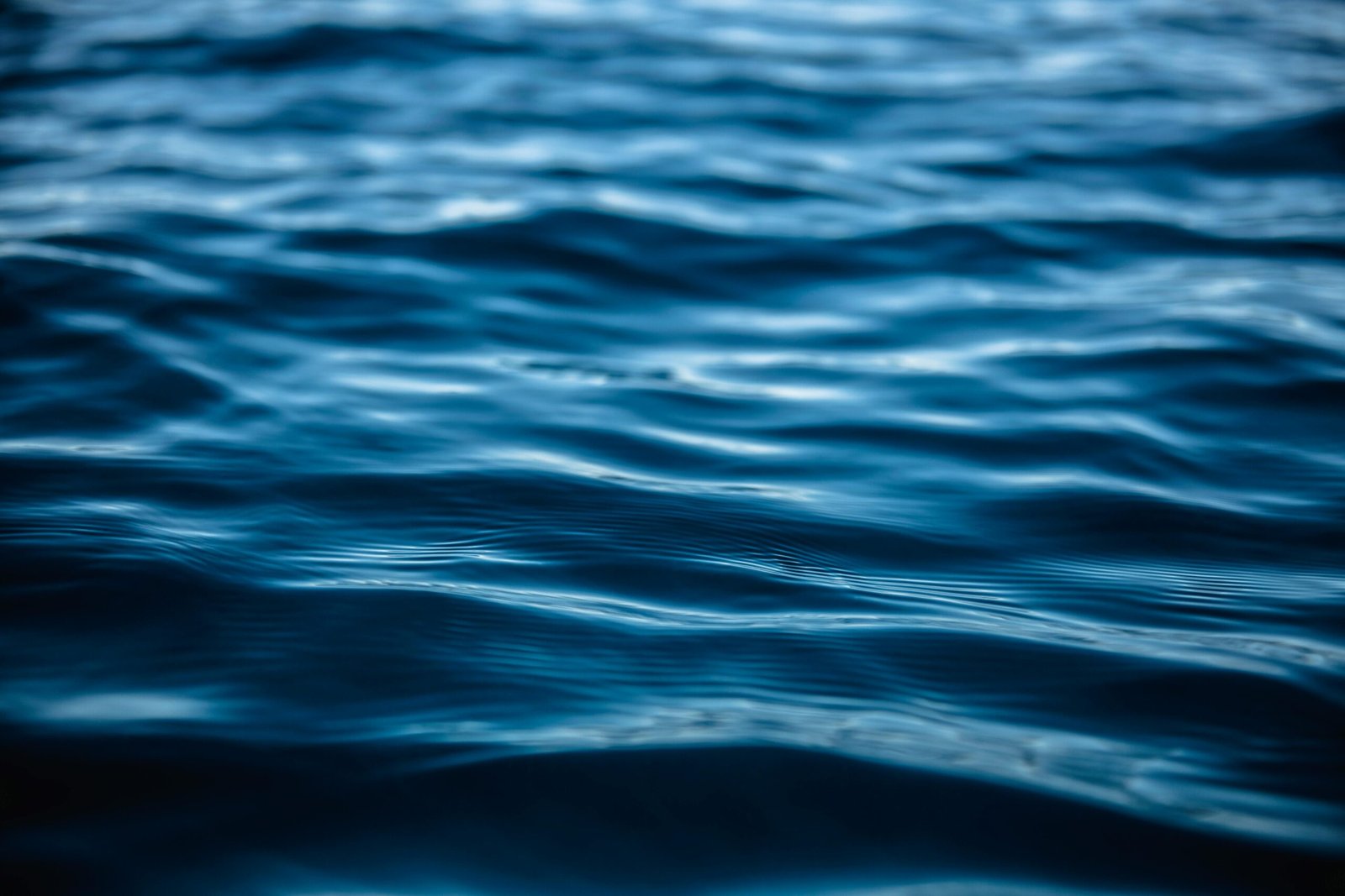 Close-up view of tranquil ocean waves with blue hues illustrating serenity and nature's beauty.